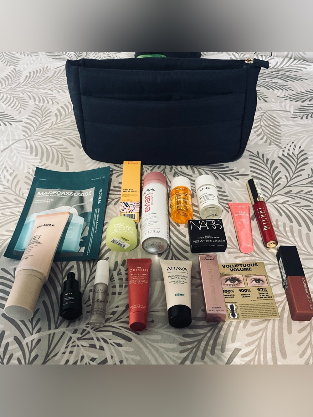 Ulta Navy Quilted Cosmetic Organizer Bag with assorted cosmetics